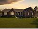 Charming brick home at sunset featuring a well-manicured lawn and inviting front porch at 760 Community Ave, Smoaks, SC 29481