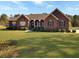 Charming brick home with a well-manicured lawn and inviting front porch at 760 Community Ave, Smoaks, SC 29481