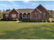 Charming brick home with a well-manicured lawn and inviting front porch at 760 Community Ave, Smoaks, SC 29481