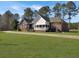 Charming brick home with covered front porch and sprawling green lawn at 760 Community Ave, Smoaks, SC 29481