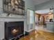 A cozy fireplace adds warmth and ambiance to the living area with adjacent dining room at 760 Community Ave, Smoaks, SC 29481