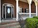 Close up of a brick porch with columns and a decorative front door at 760 Community Ave, Smoaks, SC 29481