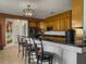 Updated kitchen featuring a breakfast bar with seating, stainless steel appliances, and granite countertops at 760 Community Ave, Smoaks, SC 29481