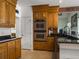 Modern kitchen with stainless steel double ovens, wooden cabinets, granite countertops, and access to the breakfast nook at 760 Community Ave, Smoaks, SC 29481
