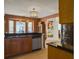Eat in kitchen area with window views, stainless steel dishwasher and wooden cabinetry at 760 Community Ave, Smoaks, SC 29481