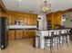 Spacious kitchen with stainless steel appliances, granite countertops, a breakfast bar, and wooden cabinets at 760 Community Ave, Smoaks, SC 29481