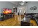 Open living room with hardwood floors, vaulted ceiling, and comfortable leather seating at 760 Community Ave, Smoaks, SC 29481