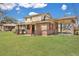 Expansive backyard with manicured lawn, covered patio, and exterior brick accents, ideal for outdoor enjoyment at 7659 Allwood Ave, North Charleston, SC 29418