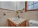 Bathroom featuring a vanity with sink, a window and beige tiling at 7659 Allwood Ave, North Charleston, SC 29418