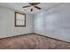 A carpeted bedroom with natural light from a window and a ceiling fan at 7659 Allwood Ave, North Charleston, SC 29418