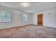 Bright bedroom with carpeted floors and window views at 7659 Allwood Ave, North Charleston, SC 29418