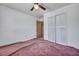 A bedroom with a ceiling fan and large closet with white bi-fold doors at 7659 Allwood Ave, North Charleston, SC 29418