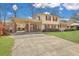 Charming home with a covered driveway, well-kept lawn, and brick accents, showcasing curb appeal and functionality at 7659 Allwood Ave, North Charleston, SC 29418