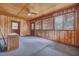 Spacious living room with wood-paneled walls, multiple windows, and wood-look floors at 7659 Allwood Ave, North Charleston, SC 29418