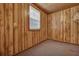 Neutral room with wood paneled walls and a window, offering a cozy and inviting space at 7659 Allwood Ave, North Charleston, SC 29418