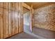 Spacious room featuring wood paneled walls, neutral carpet, and access to another room, providing versatile space at 7659 Allwood Ave, North Charleston, SC 29418
