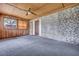 Spacious sunroom featuring brick wall, wood paneled walls, and neutral carpet, perfect for relaxation and entertainment at 7659 Allwood Ave, North Charleston, SC 29418