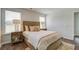 Bright bedroom showcasing a comfortable bed, wood flooring, and natural light from two windows at 8018 Rackham Rd, Hollywood, SC 29470
