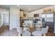 The dining area showcases hardwood floors and stainless steel appliances at 8018 Rackham Rd, Hollywood, SC 29470