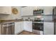 Modern kitchen with stainless steel appliances, white cabinets, and hardwood floors at 8018 Rackham Rd, Hollywood, SC 29470