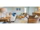 Comfortable living room with hardwood floors, neutral sofa, and wicker chairs at 8018 Rackham Rd, Hollywood, SC 29470