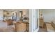 Bright living room featuring hardwood floors, neutral sofa, wicker chairs, and an open concept kitchen at 8018 Rackham Rd, Hollywood, SC 29470