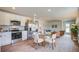 Open-concept kitchen, dining, and living room with hardwood floors and stainless steel appliances at 8018 Rackham Rd, Hollywood, SC 29470