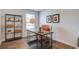 Well-lit home office space with wood floors, modern decor, and a storage shelf at 8018 Rackham Rd, Hollywood, SC 29470