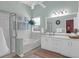 A well-lit bathroom featuring a soaking tub, glass shower, and double vanity, complemented by a hanging plant at 8506 Kennestone Ln, North Charleston, SC 29420