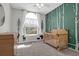Charming Bedroom with woodland-themed decor and a natural wood crib by a sunny window at 8506 Kennestone Ln, North Charleston, SC 29420