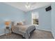 Bedroom with blue walls, neutral carpet, side tables with lamps, and a window with privacy blinds at 8506 Kennestone Ln, North Charleston, SC 29420