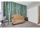 Cozy Bedroom featuring a wooden crib and a playful tree-themed wall at 8506 Kennestone Ln, North Charleston, SC 29420
