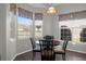 Bright breakfast nook with floral valances and a round table bathed in sunlight from many windows at 8506 Kennestone Ln, North Charleston, SC 29420
