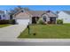 Well-maintained home with tidy landscaping, a two-car garage, and a neat front yard on a sunny day at 8506 Kennestone Ln, North Charleston, SC 29420
