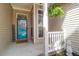 A welcoming covered front porch has decorative wreath on the door and a charming fern at 8506 Kennestone Ln, North Charleston, SC 29420