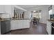 Updated eat-in kitchen featuring white cabinets, stainless steel appliances, and view into the living area at 8506 Kennestone Ln, North Charleston, SC 29420