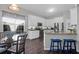 Updated eat-in kitchen featuring white cabinets, stainless steel appliances, and breakfast nook seating at 8506 Kennestone Ln, North Charleston, SC 29420