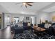 Well-lit living room showcases hardwood flooring and seamless transition to dining and kitchen areas at 8506 Kennestone Ln, North Charleston, SC 29420