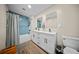 Stylish bathroom featuring double sinks, modern fixtures, and blue tiled shower at 914 King Richard Dr, Charleston, SC 29407
