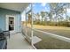 Screened porch with comfortable chair overlooking green backyard at 103 Cotesworth Ct, Summerville, SC 29486