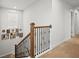 Staircase with carpet and wooden railings plus decorative wall hangings near a window at 103 Cotesworth Ct, Summerville, SC 29486