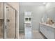 En suite bathroom featuring a tiled shower, double sink vanity, and a view into the bedroom at 1047 Tea Time Dr, Summerville, SC 29485