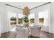 Bright dining nook with large windows, a stylish light fixture, and a lovely view at 1047 Tea Time Dr, Summerville, SC 29485