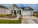 Charming one-story home with well-manicured lawn, a welcoming front porch and a two-car garage at 1047 Tea Time Dr, Summerville, SC 29485