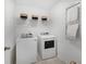 Well-lit laundry room with modern washer and dryer, shelving, and hanging rack at 1047 Tea Time Dr, Summerville, SC 29485