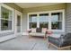 Charming patio with a bench seat, decorative pillows, and a cozy spot for outdoor relaxation and entertaining at 1047 Tea Time Dr, Summerville, SC 29485