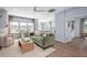 Sunlit living room with hardwood floors, stylish seating, and an open view of the modern kitchen at 1058 Tea Time Dr, Summerville, SC 29485