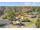Beautiful aerial view of a charming brick home with a circular driveway, surrounded by mature trees and lush greenery at 107 Minus St, Saint George, SC 29477