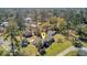 Lovely aerial view of a well-maintained brick home with a lush lawn and mature trees in a quiet residential neighborhood at 107 Minus St, Saint George, SC 29477