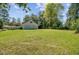 Large, green backyard featuring a detached garage and ample space for outdoor activities at 107 Minus St, Saint George, SC 29477